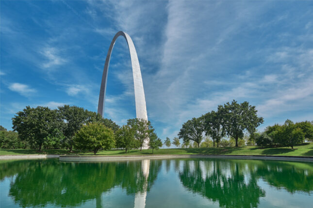 Arch reflecting in water during daytime