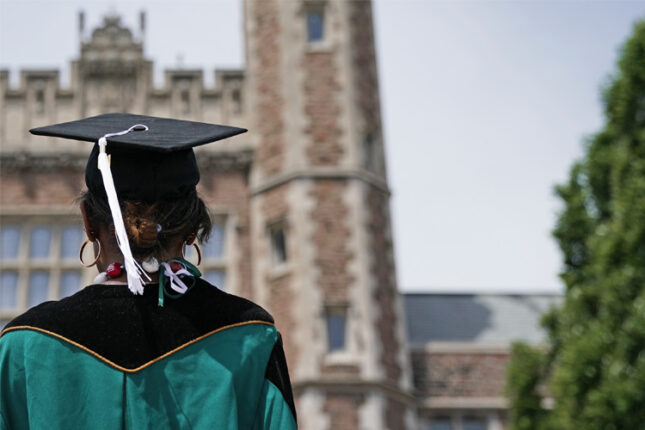 A graduate looks up to Brookings Hall